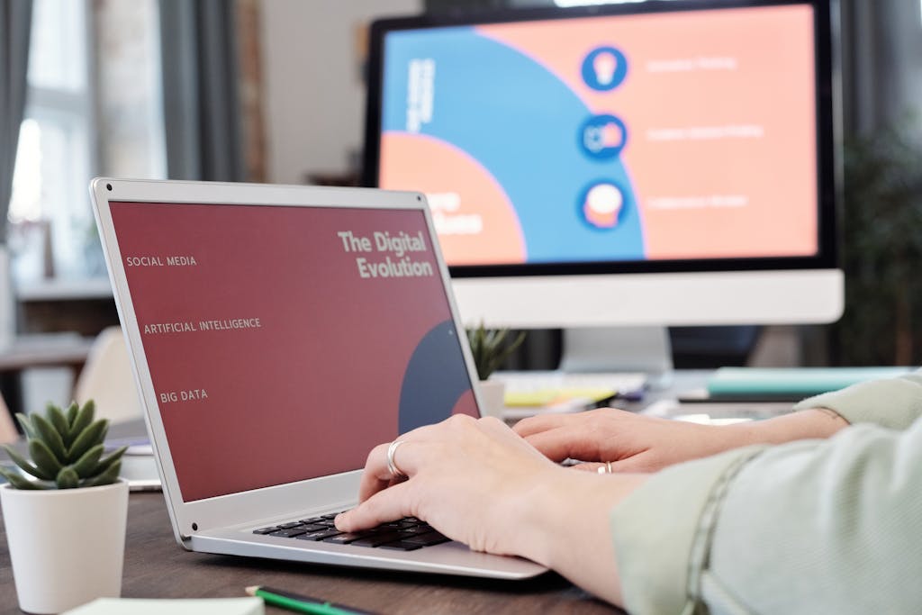 Laptop user typing with digital evolution concept on screen in a modern office environment.