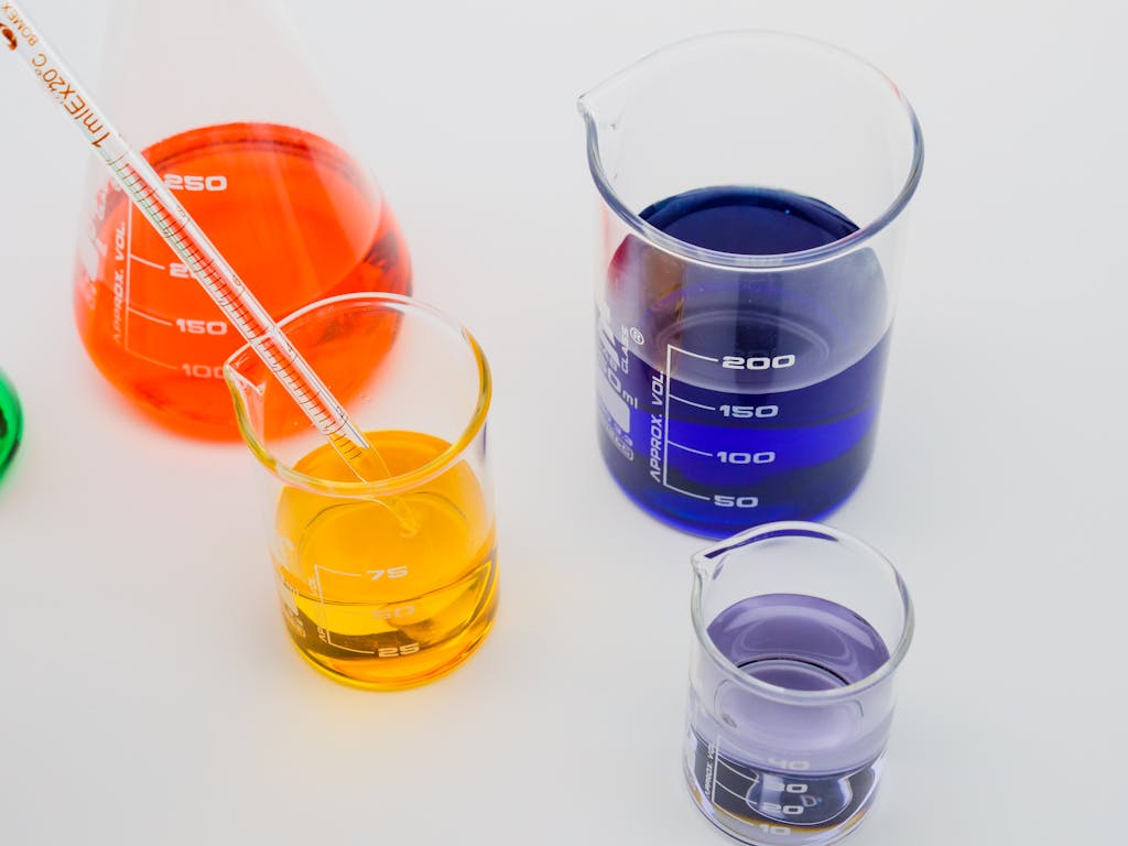 Vibrant laboratory beakers with colored liquids in a scientific setting.